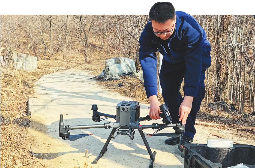 丹东市五道沟专业森林消防队队员罗瑞宸正在调试无人机，做巡护山林的准备。 记者 王卢莎 摄